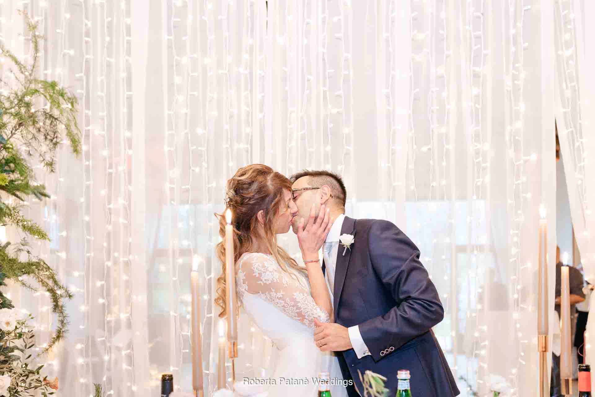 bride and groom kiss
